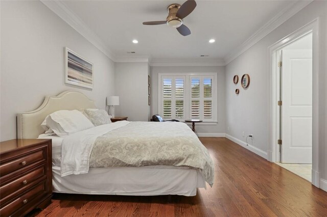 bedroom featuring ceiling fan, crown molding, and wood-type flooring