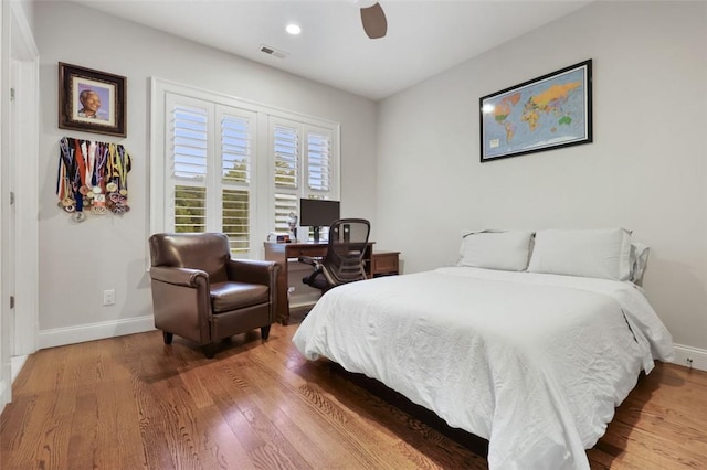 bedroom featuring hardwood / wood-style flooring and ceiling fan