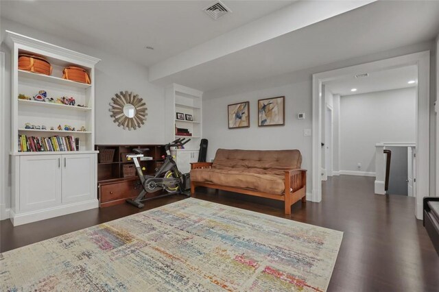 living area featuring built in features and dark hardwood / wood-style floors