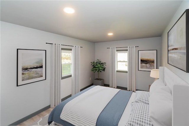 bedroom featuring light hardwood / wood-style floors and multiple windows