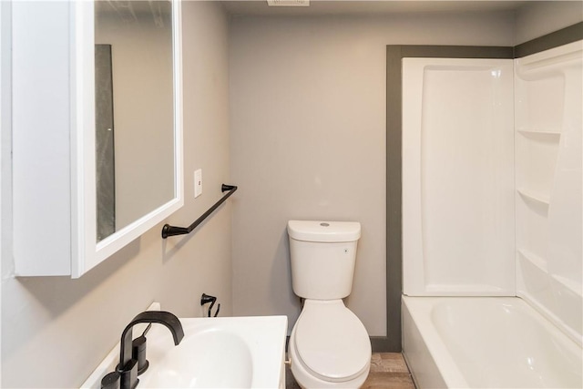 full bathroom featuring shower / bathing tub combination, toilet, and sink