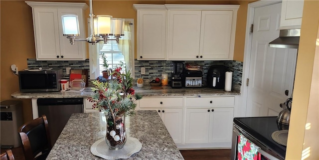 kitchen with light stone countertops, stainless steel appliances, white cabinetry, and tasteful backsplash