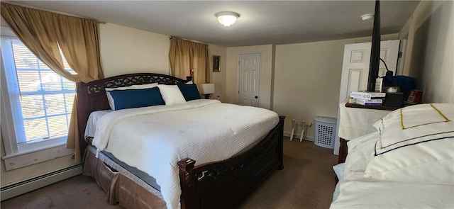 bedroom with a baseboard radiator, dark carpet, and multiple windows