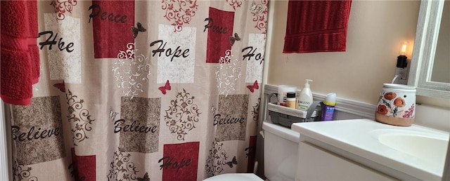 bathroom with a shower with curtain and toilet