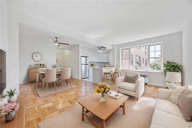 living room with radiator and light parquet floors