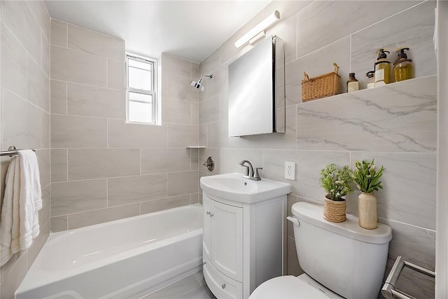 full bathroom with tasteful backsplash, toilet, vanity, tile walls, and tiled shower / bath