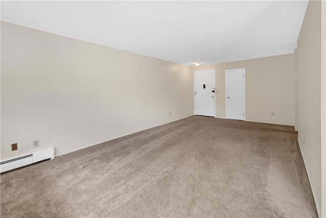 unfurnished room featuring baseboard heating and carpet