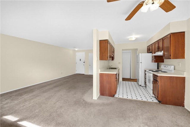 kitchen with light carpet, white range with electric stovetop, ceiling fan, and sink