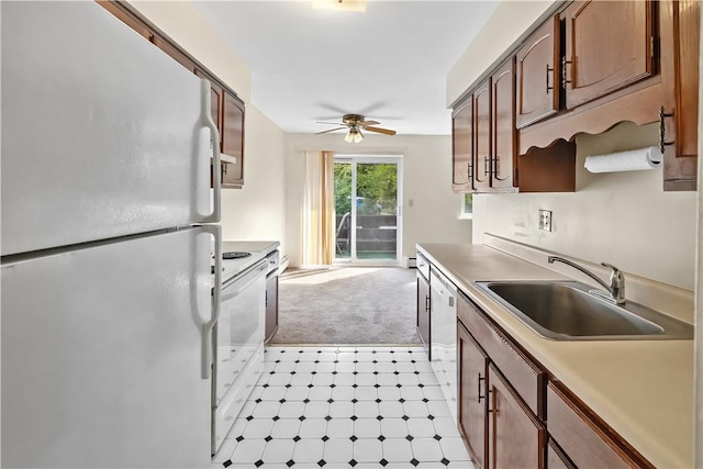 kitchen featuring white appliances, light carpet, sink, ceiling fan, and a baseboard radiator