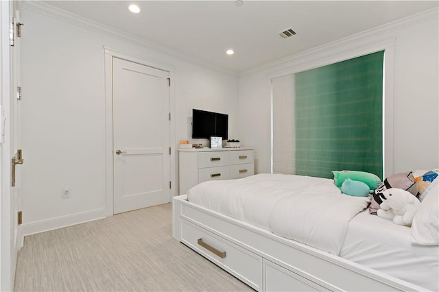 bedroom with crown molding and light wood-type flooring