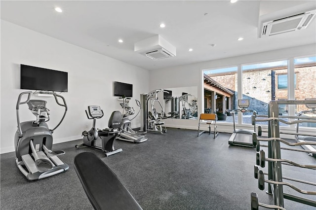 workout area featuring a wall mounted air conditioner