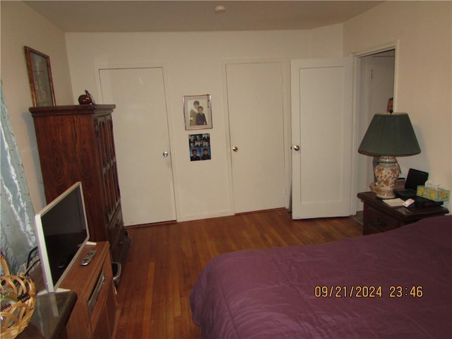 bedroom with dark wood-type flooring