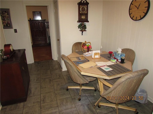 dining area with dark tile patterned floors