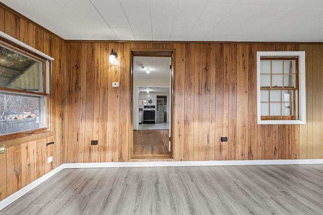 spare room featuring wood walls and hardwood / wood-style flooring