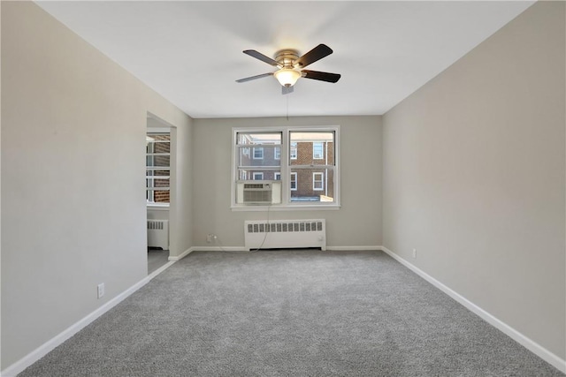 unfurnished room featuring carpet, radiator, and ceiling fan