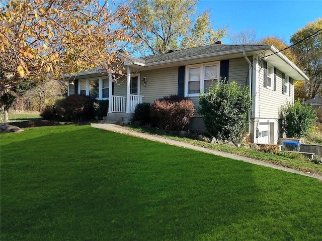 ranch-style house with covered porch and a front yard