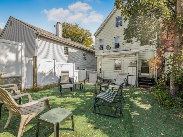 back of house featuring a yard