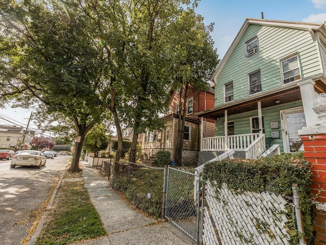 350 S 2nd Ave, Mount Vernon, NY 10550 - view of front of house with covered porch, a fenced front yard, and a gate
