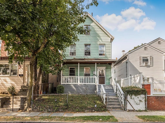 350 S 2nd Ave, Mount Vernon, NY 10550 - view of front of property featuring a porch, a fenced front yard, and stairs