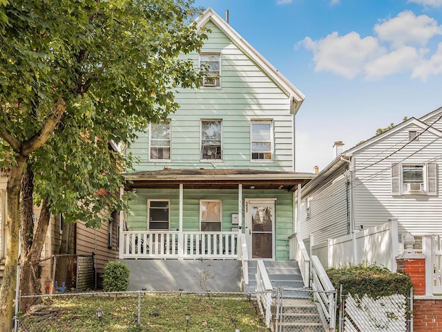 350 S 2nd Ave, Mount Vernon, NY 10550 - view of front facade with a porch, a gate, and a fenced front yard