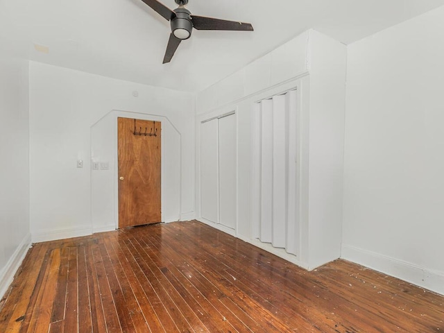 empty room with ceiling fan and hardwood / wood-style flooring