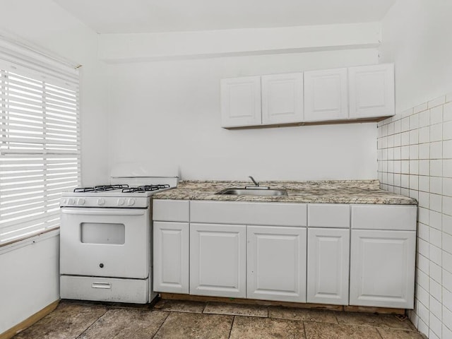 350 S 2nd Ave, Mount Vernon, NY 10550 - kitchen with a sink, white range with gas stovetop, white cabinets, tile walls, and light stone countertops
