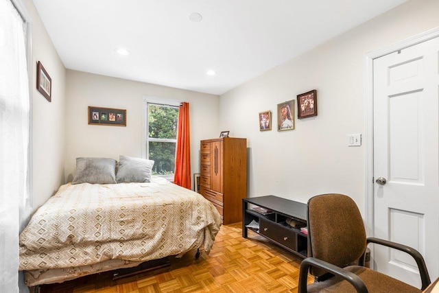 bedroom with light parquet floors