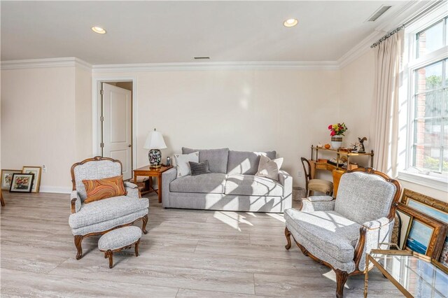 living room featuring plenty of natural light, light hardwood / wood-style floors, and ornamental molding