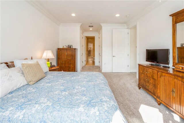 bedroom with crown molding and light colored carpet