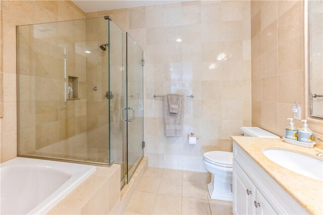 full bathroom with tile patterned flooring, toilet, vanity, independent shower and bath, and tile walls