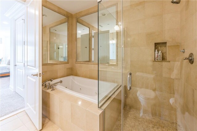 bathroom featuring tile patterned floors and separate shower and tub