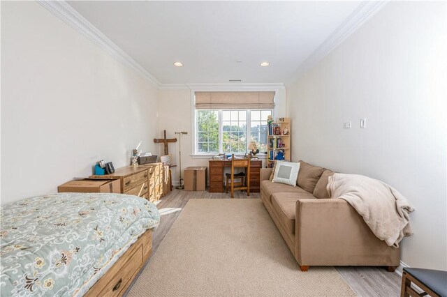 bedroom featuring light wood-type flooring and ornamental molding