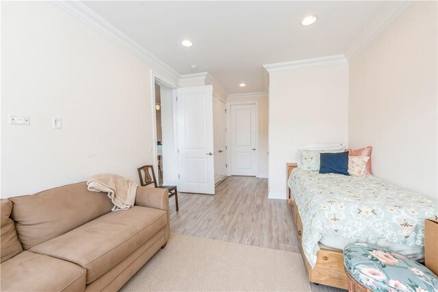 bedroom featuring light hardwood / wood-style flooring and ornamental molding