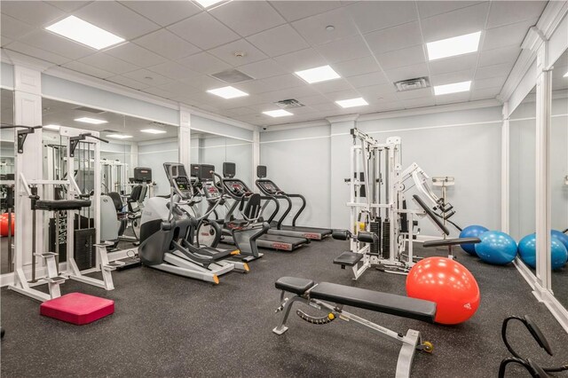 gym featuring a paneled ceiling