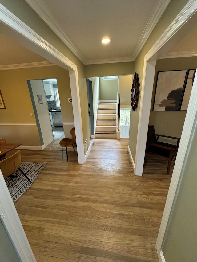 corridor with wood-type flooring and ornamental molding