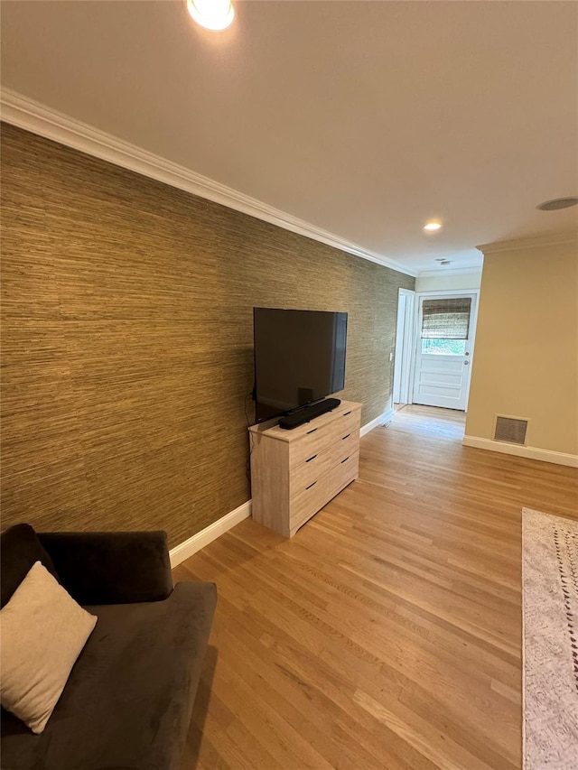 living room with hardwood / wood-style floors and crown molding