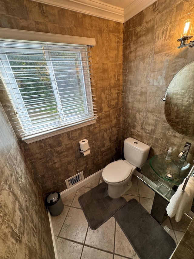 bathroom featuring ornamental molding, tile walls, and toilet