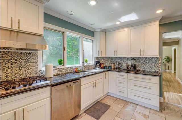 kitchen featuring dark stone counters, crown molding, and stainless steel appliances