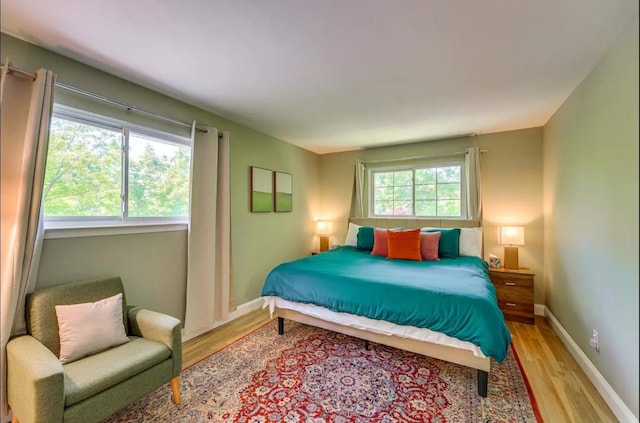 bedroom featuring light wood-type flooring and multiple windows