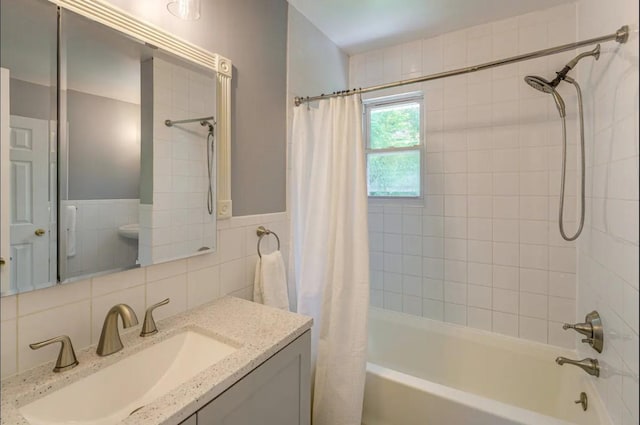 bathroom featuring shower / bath combo, tile walls, vanity, and tasteful backsplash