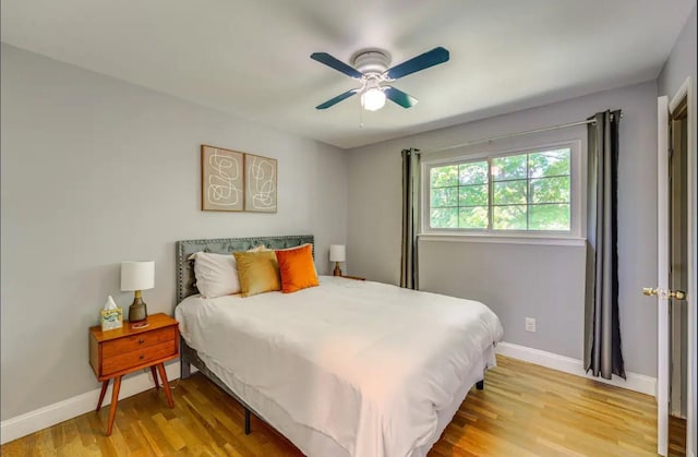 bedroom with light hardwood / wood-style floors and ceiling fan