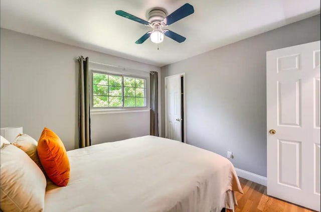 bedroom with ceiling fan and light hardwood / wood-style flooring