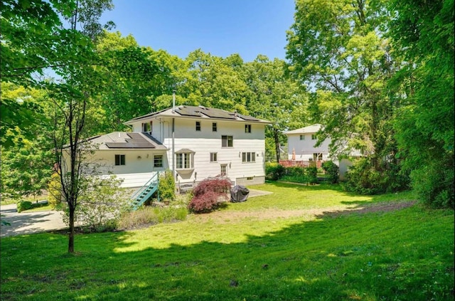 rear view of property featuring a yard