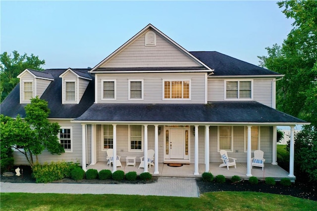 rear view of property featuring a porch