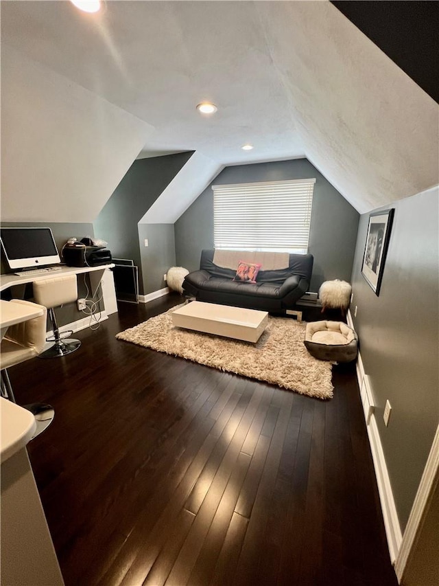 interior space featuring dark hardwood / wood-style flooring and vaulted ceiling