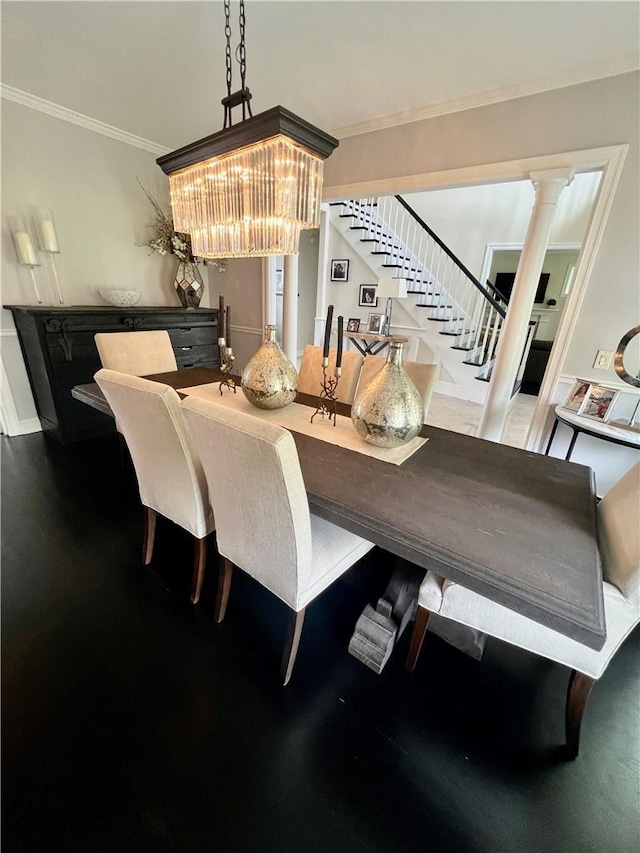 dining space featuring a chandelier, decorative columns, and ornamental molding