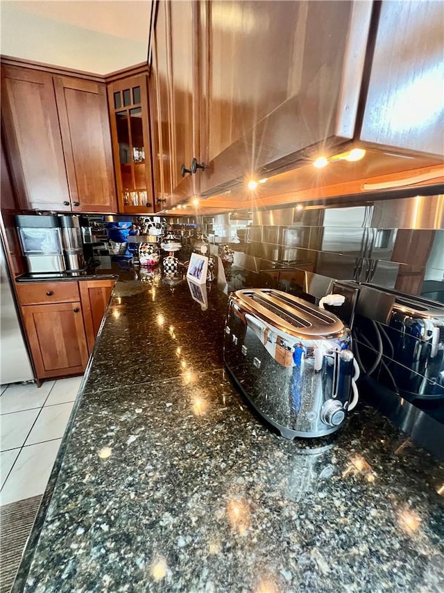 kitchen featuring light tile patterned floors and dark stone counters