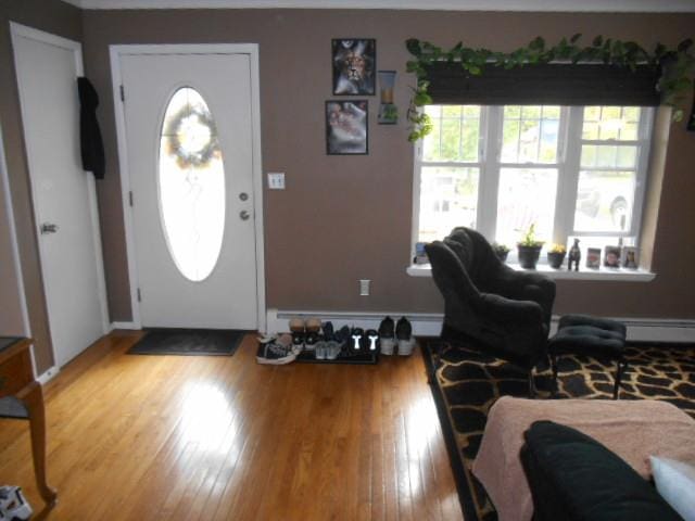 entryway featuring hardwood / wood-style flooring and baseboard heating