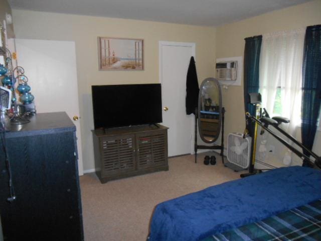 carpeted bedroom featuring a wall unit AC