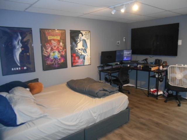 bedroom with hardwood / wood-style flooring and a drop ceiling